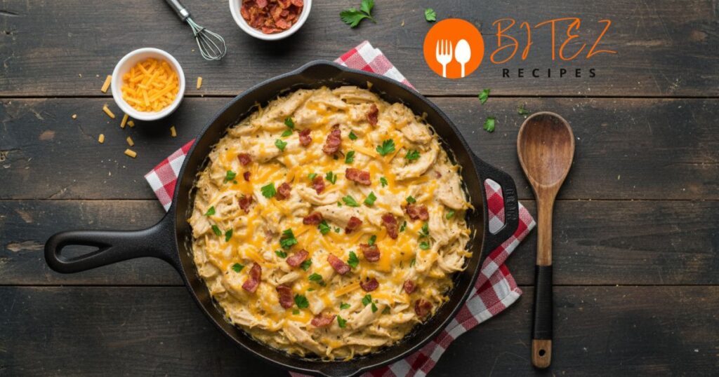 Skillet of creamy crack chicken with cheddar, bacon, and parsley.